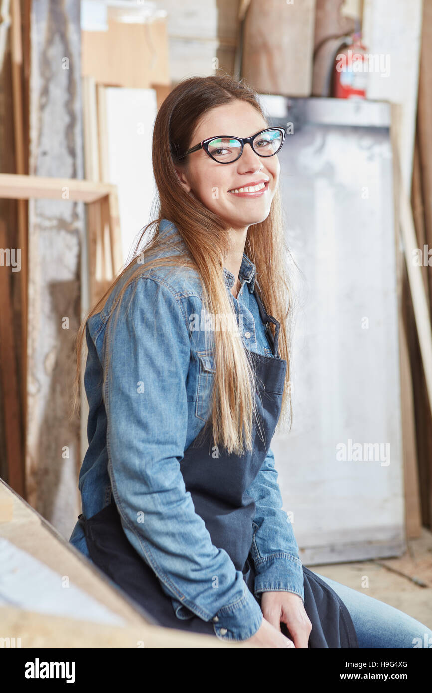 Woman as carpenter apprentice smiling content during her trainee Stock Photo