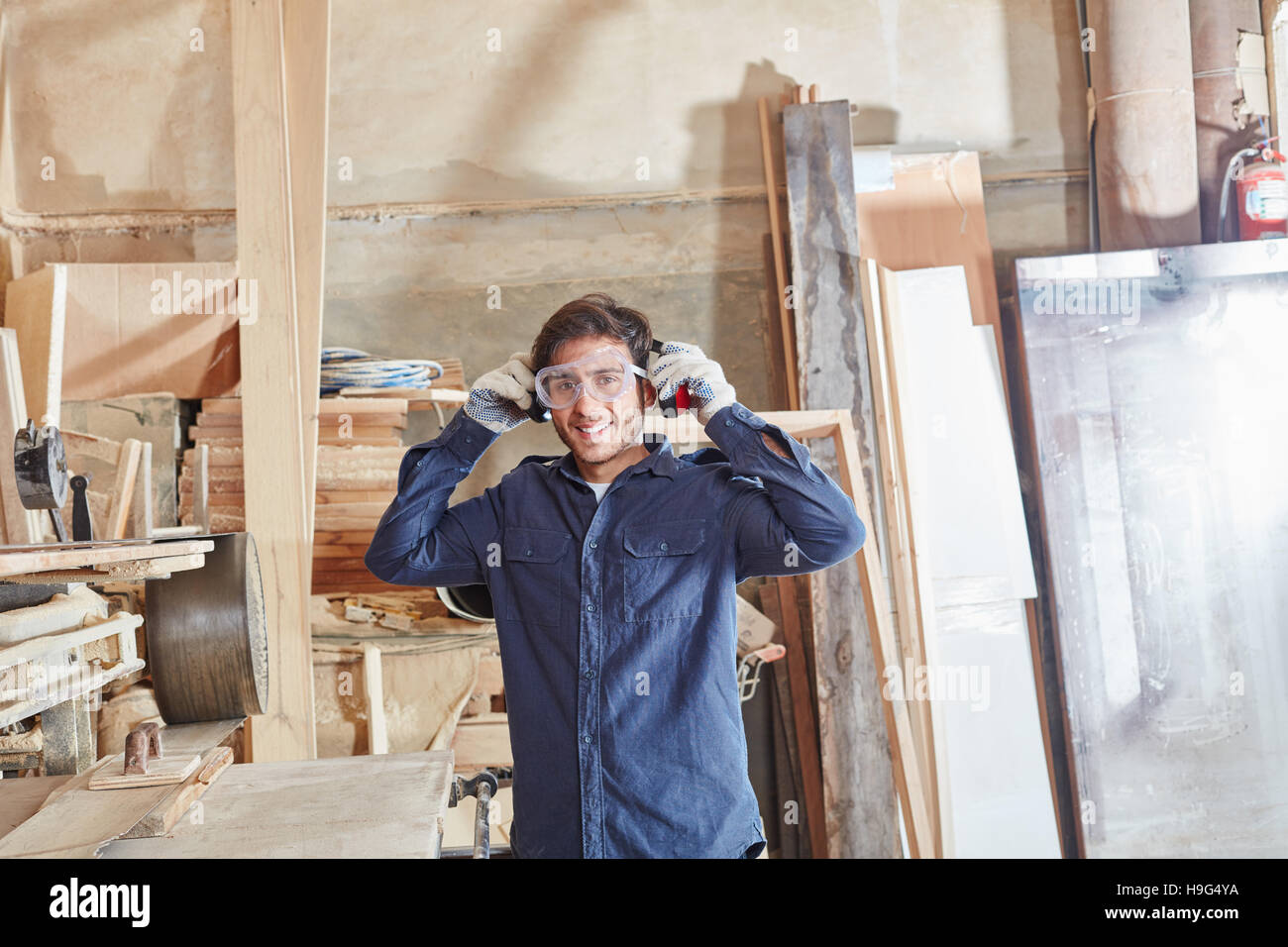 Craftsman at workshop with protective googles Stock Photo