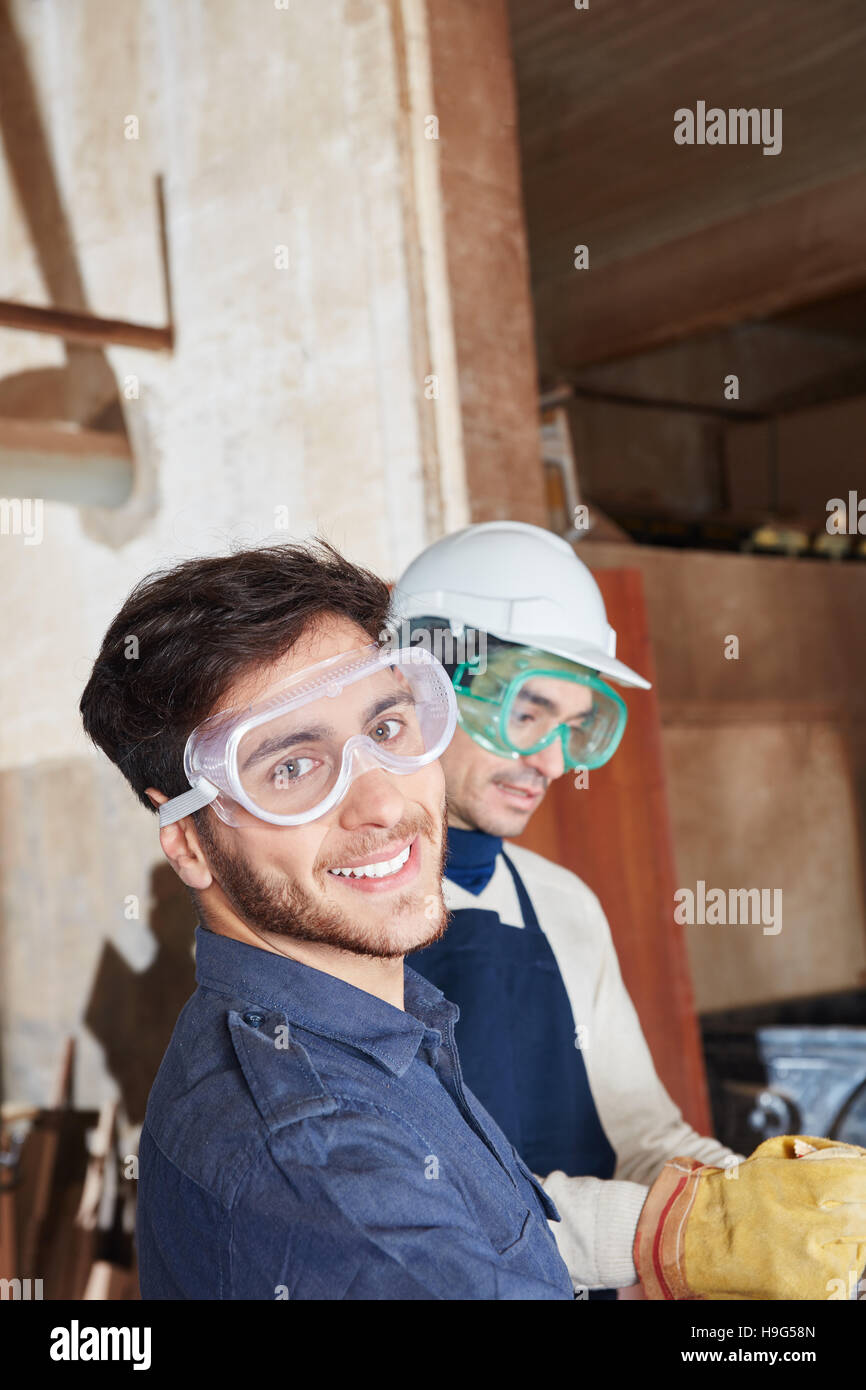 Two craftsmen at work cooperating with each other Stock Photo