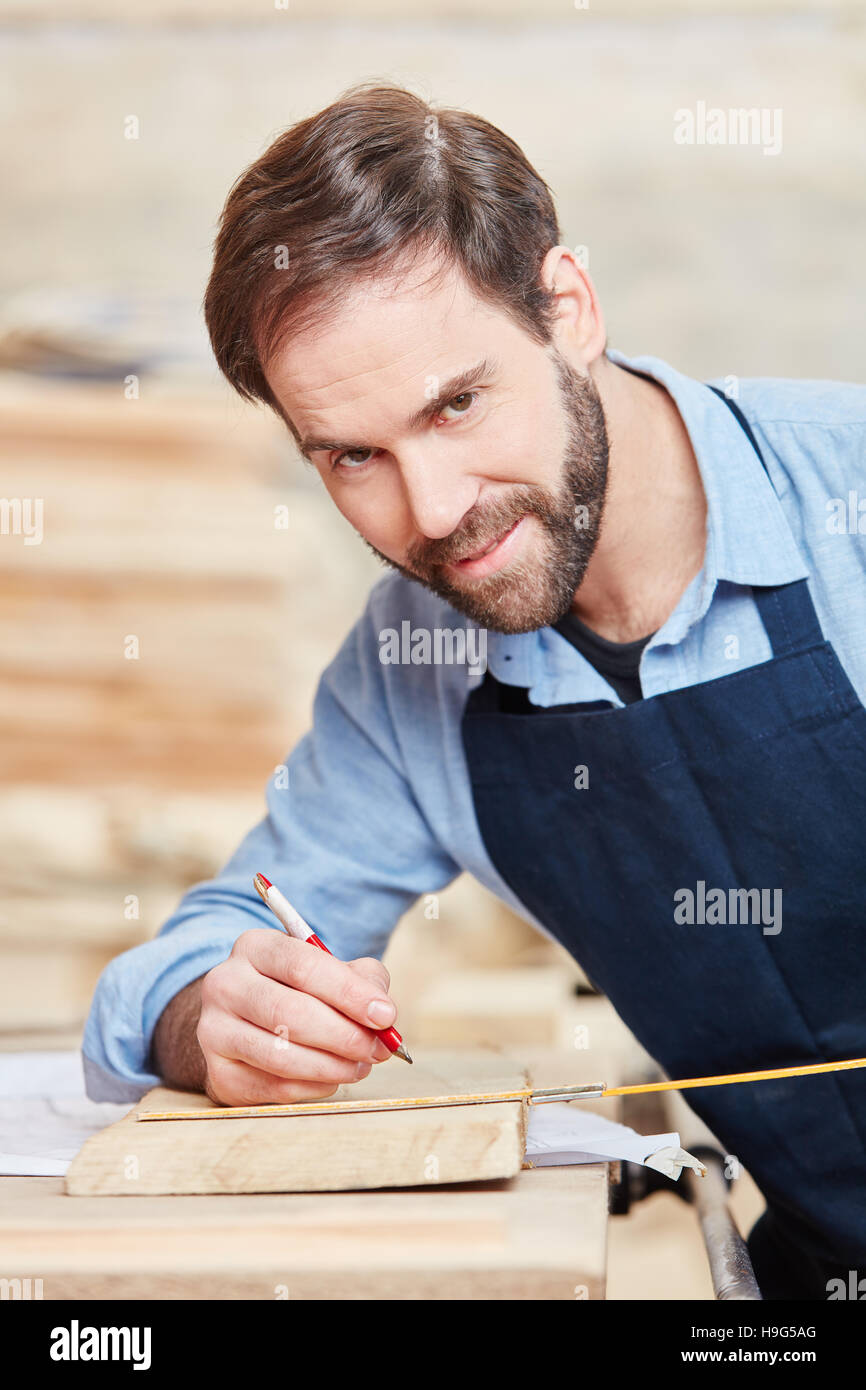 Craftsman as carpenter looking proud of his work at Stock