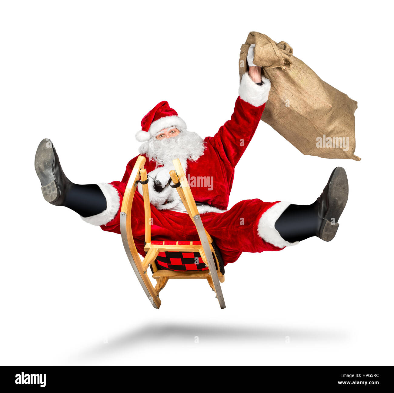 crazy santa claus on his sleigh hilarious fast funny crazy xmas christmas gift present delivery isolated white background Stock Photo