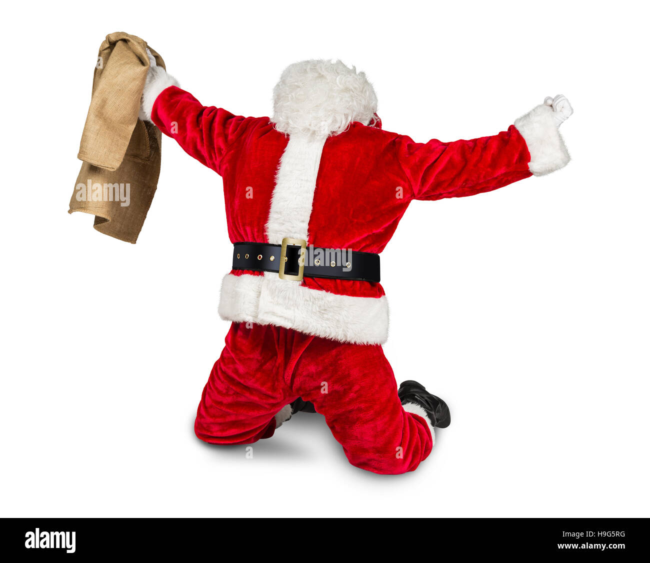 funny crazy hilarious red white santa claus celebration clench fist holding bag in the air job done isolated on white background Stock Photo