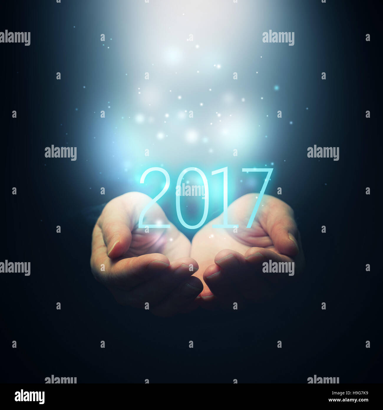 Happy new year - cupped female hands holding number 2017 Stock Photo