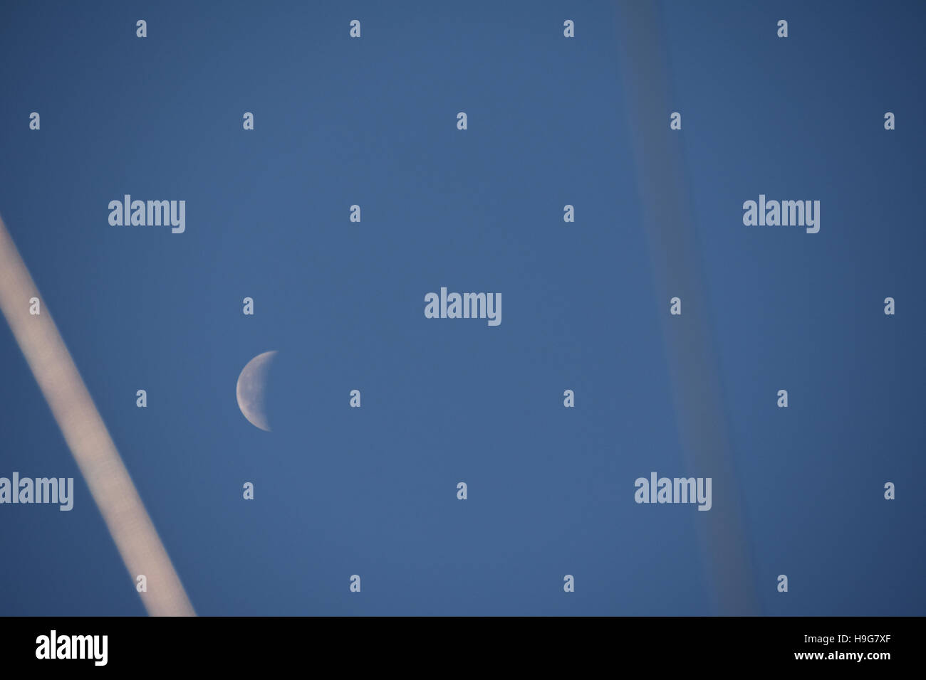 The moon seen through the rigging of a boat Stock Photo