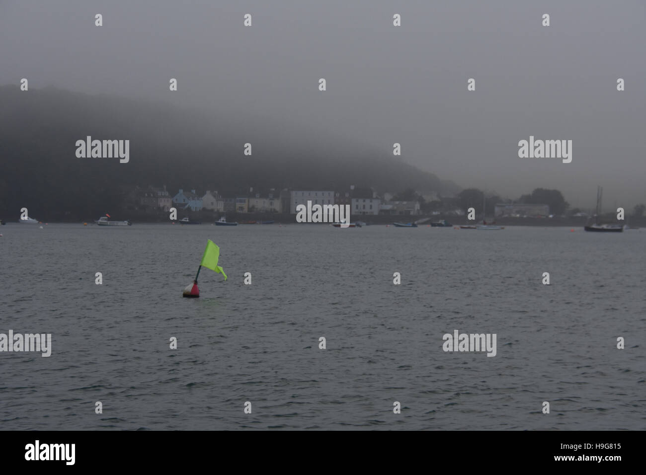 A racing marker flies in the wind as the mist rolls in at Dale reducing visibility on a calm autumn day Stock Photo