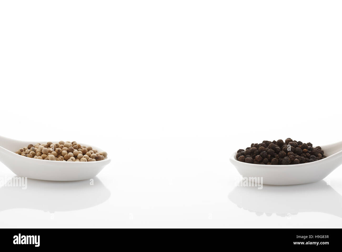 Peppercorn in porcelain spoons Stock Photo
