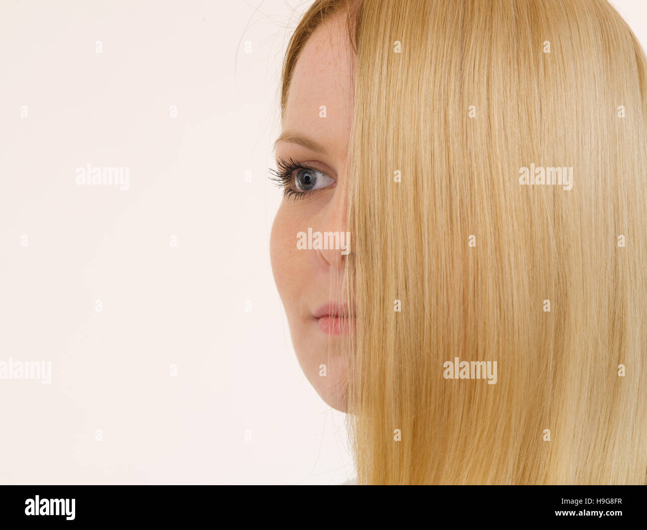 Woman with half her face covered by hair Stock Photo
