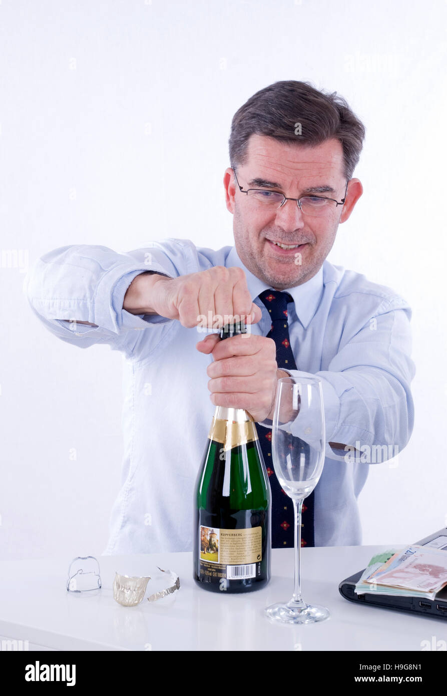 Businessman drinking sparkling wine in the office Stock Photo Alamy