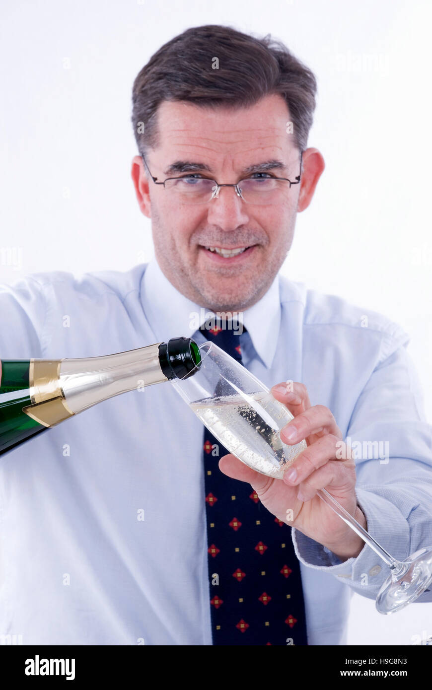 Businessman drinking sparkling wine in the office Stock Photo Alamy