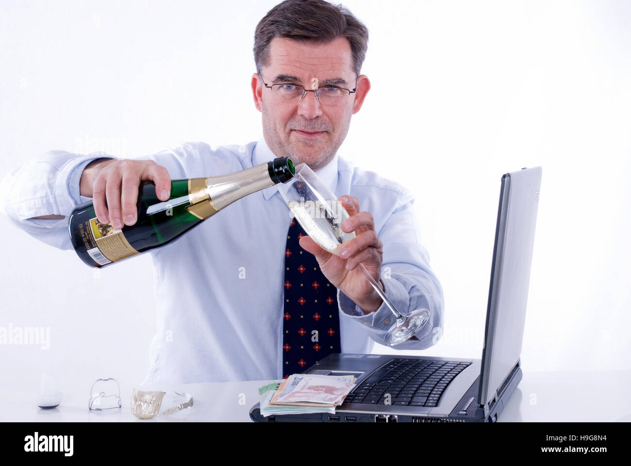 Businessman drinking sparkling wine in the office Stock Photo Alamy