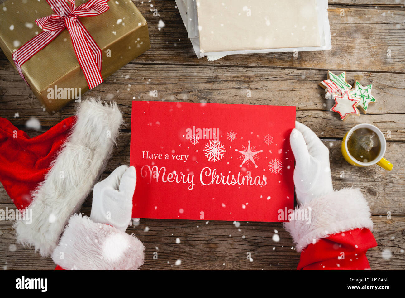 Composite image of santa claus holding a red placard Stock Photo