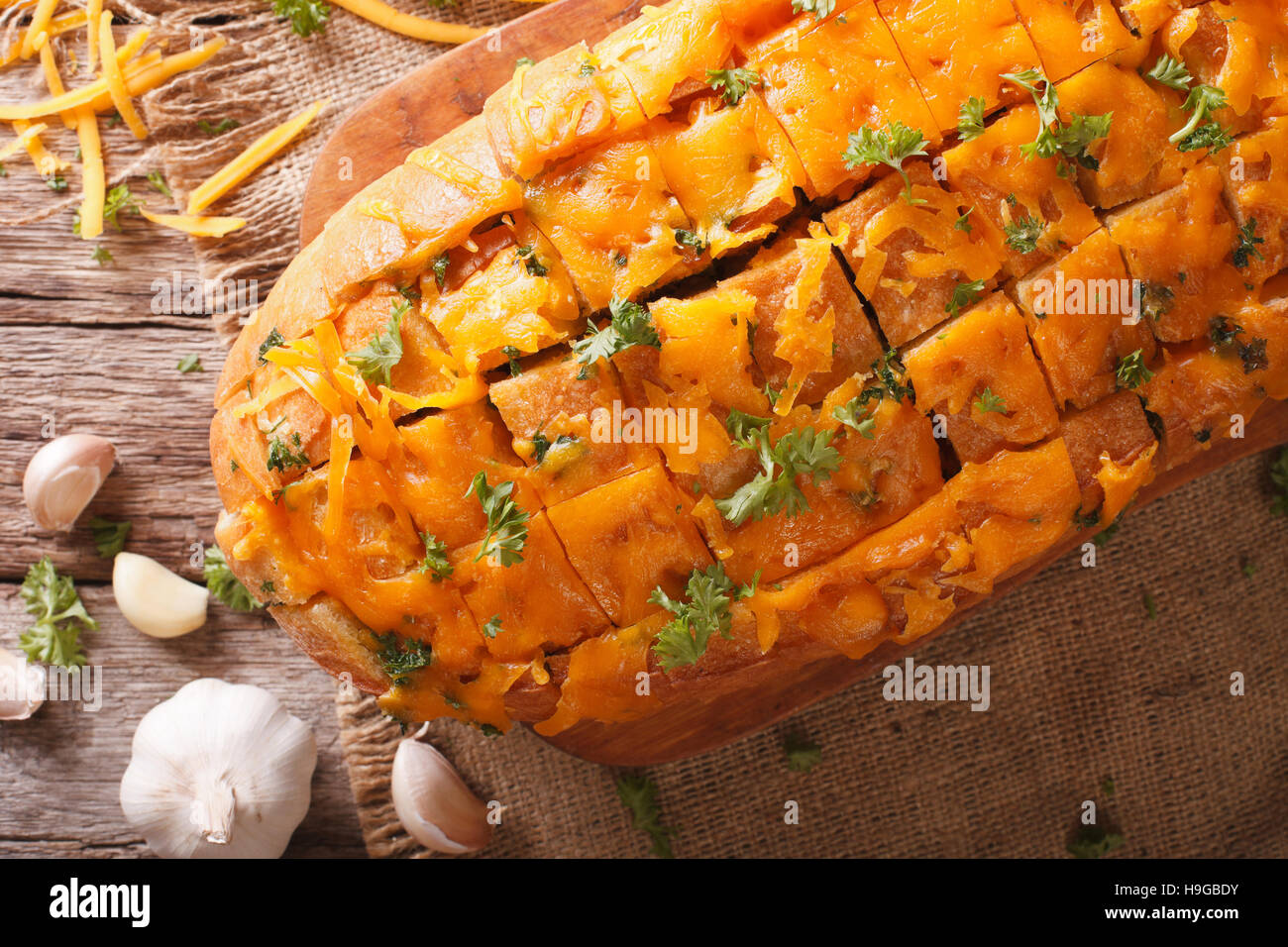 Cheddar cheese bread with garlic and herbs closeup on the table