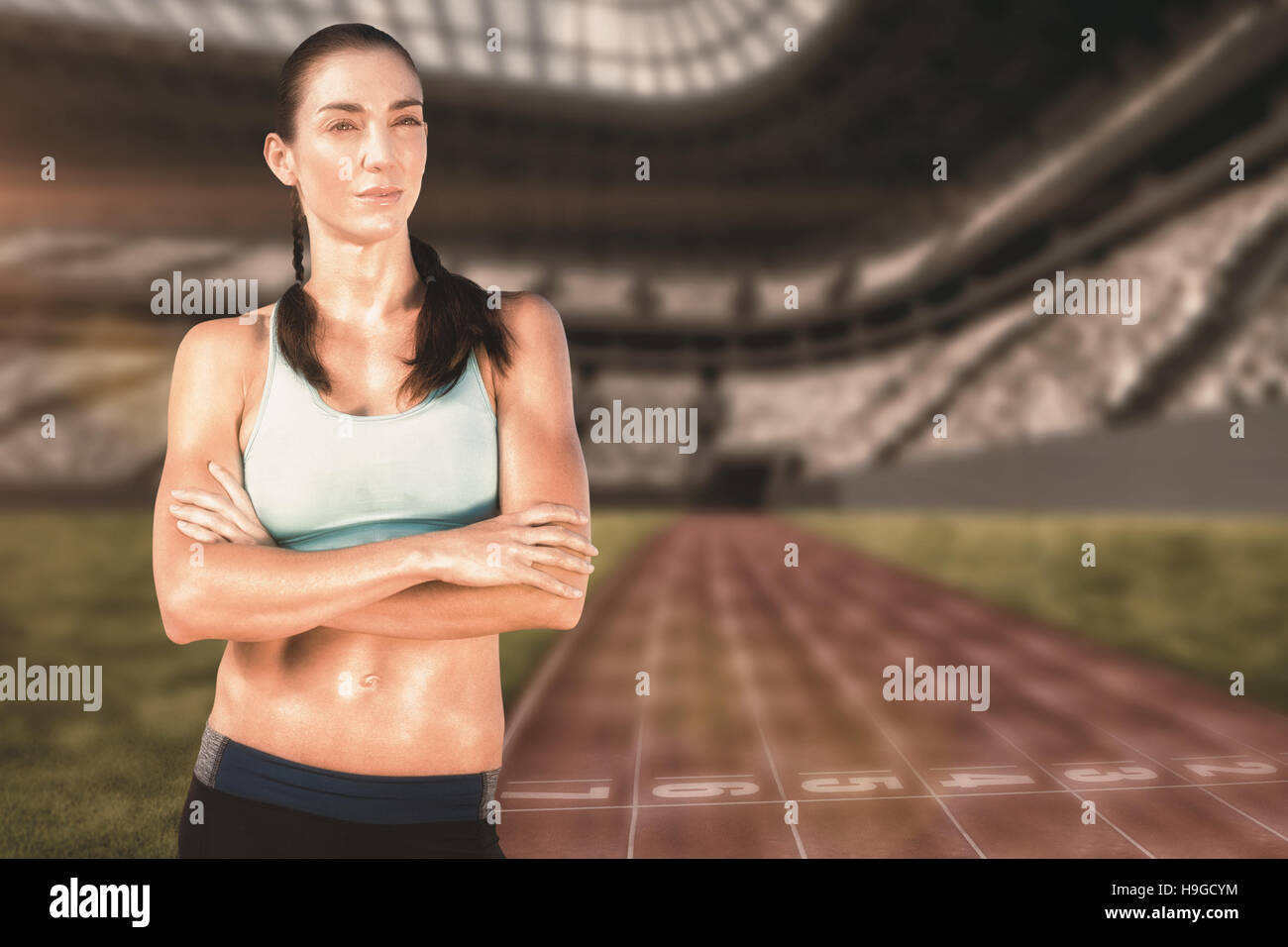 Composite image of sporty woman posing with her arms crossed Stock ...