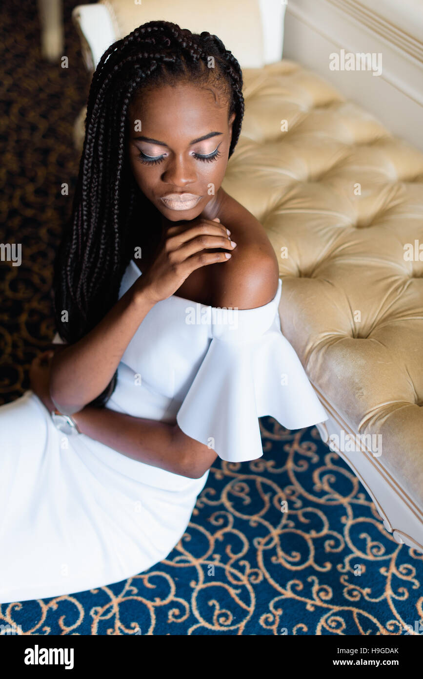black woman with beautiful face is sitting on the floor in vip hotel