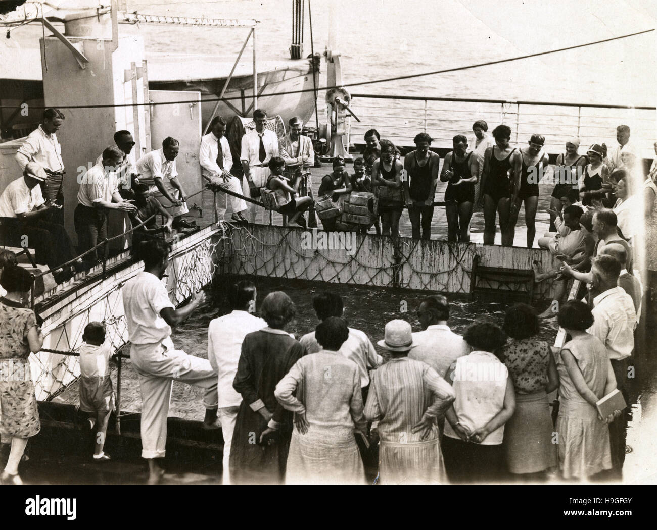 Antique c1930 photograph, passengers aboard the SS Virginia look in the swimming pool tank. SS Brazil was a US turbo-electric ocean liner. She was completed in 1928 as SS Virginia, and refitted and renamed as SS Brazil in 1938. SOURCE: ORIGINAL PHOTOGRAPHIC PRINT. Stock Photo