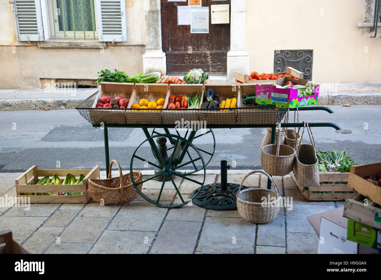 Oldfashioned fruit and vegetable cart on wheels Stock Photo 126368562