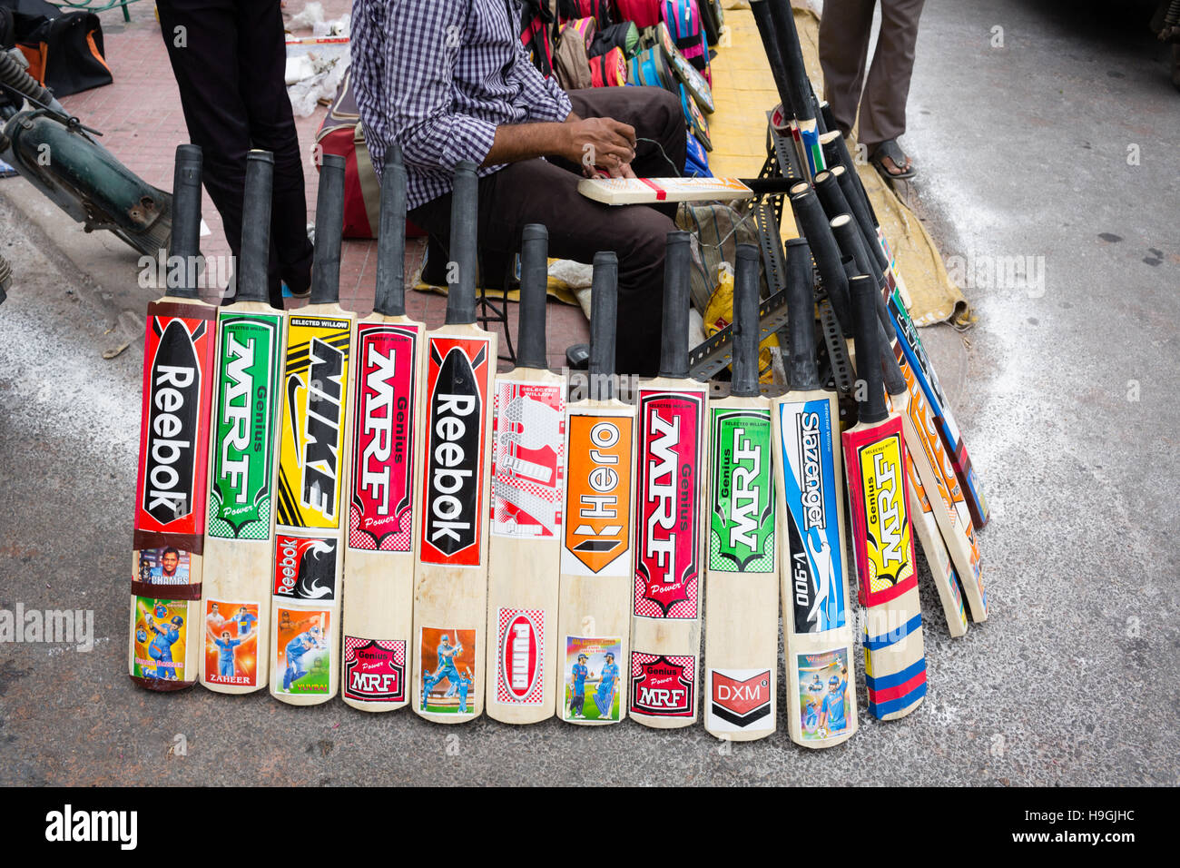 wooden cricket bats with various branded stickers on sale by a street vendor in Hyderabad,India. Stock Photo