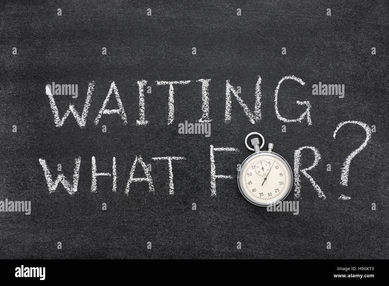 waiting what for question handwritten on chalkboard with vintage precise stopwatch used instead of O Stock Photo