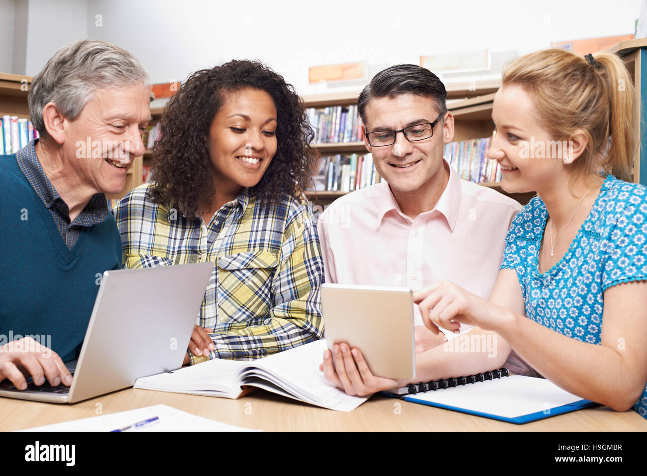 Group Of Mature Students Studying In Library Stock Photo