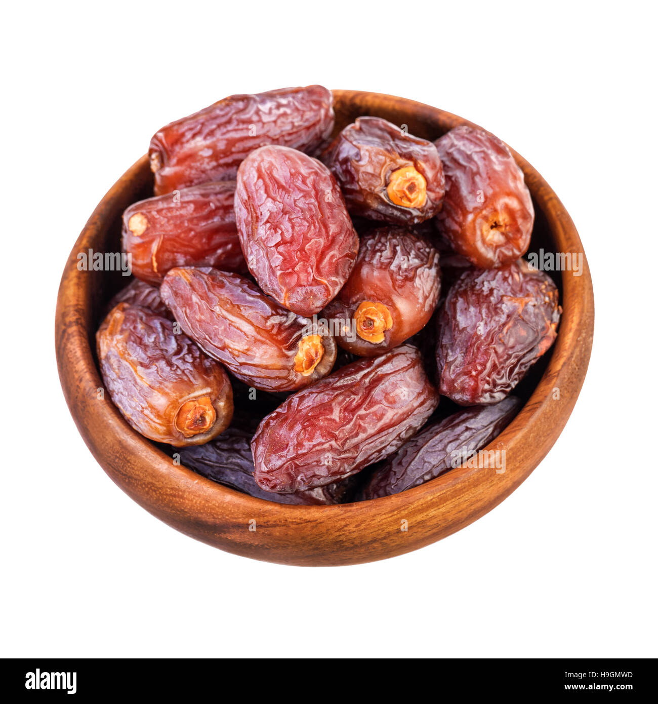 Dried dates fruits. Bowl with dry dates isolated on white, top view. Stock Photo