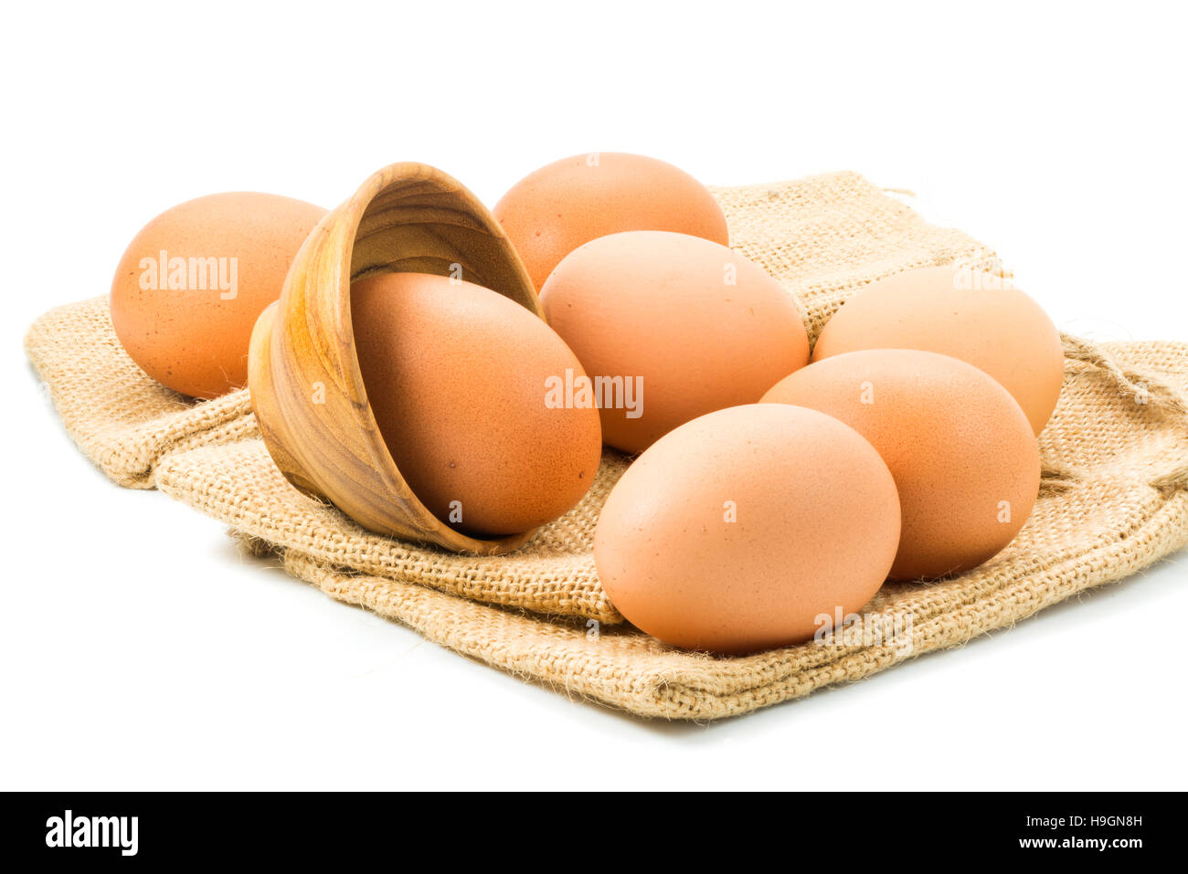 Chicken eggs and sackcloth on white background Stock Photo - Alamy