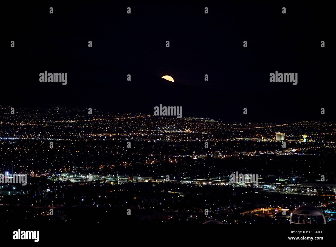 Super moon rising over an aerial view of Las Vegas city at night