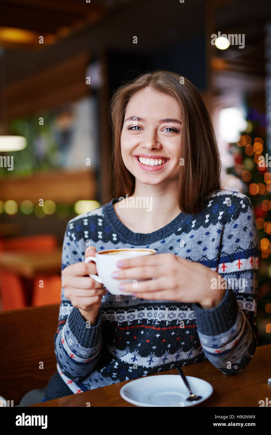 Happy girl sitting in coffee shop Stock Photo - Alamy
