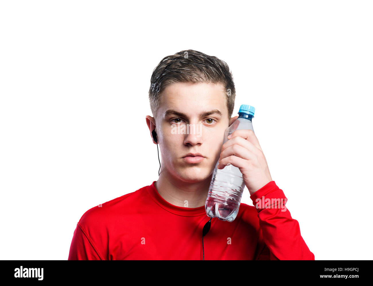 Boy with earphones and water bottle in red sweatshirt. Isolated Stock ...