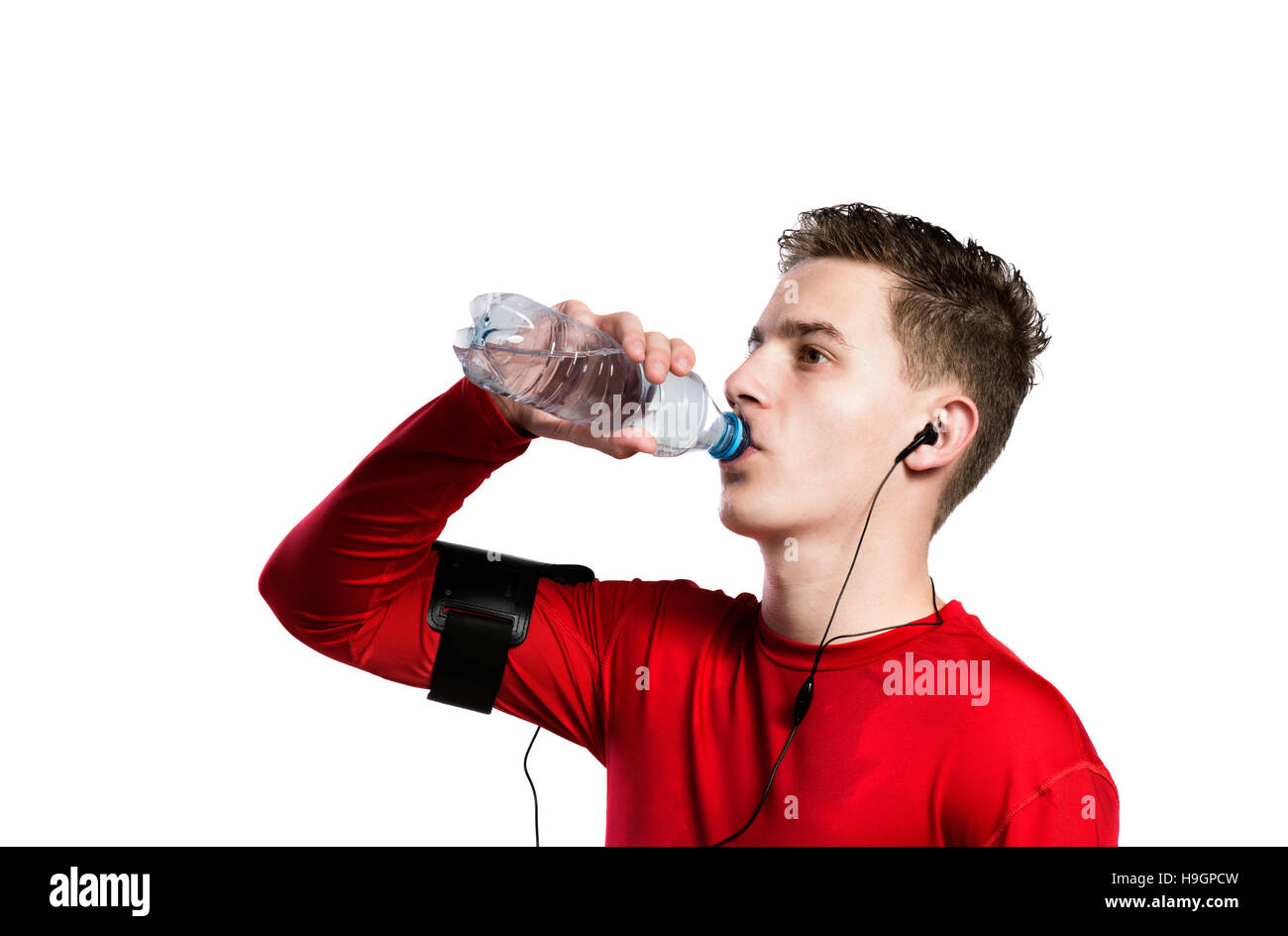 https://c8.alamy.com/comp/H9GPCW/teenage-boy-with-smartphone-and-earphones-drinking-water-isola-H9GPCW.jpg