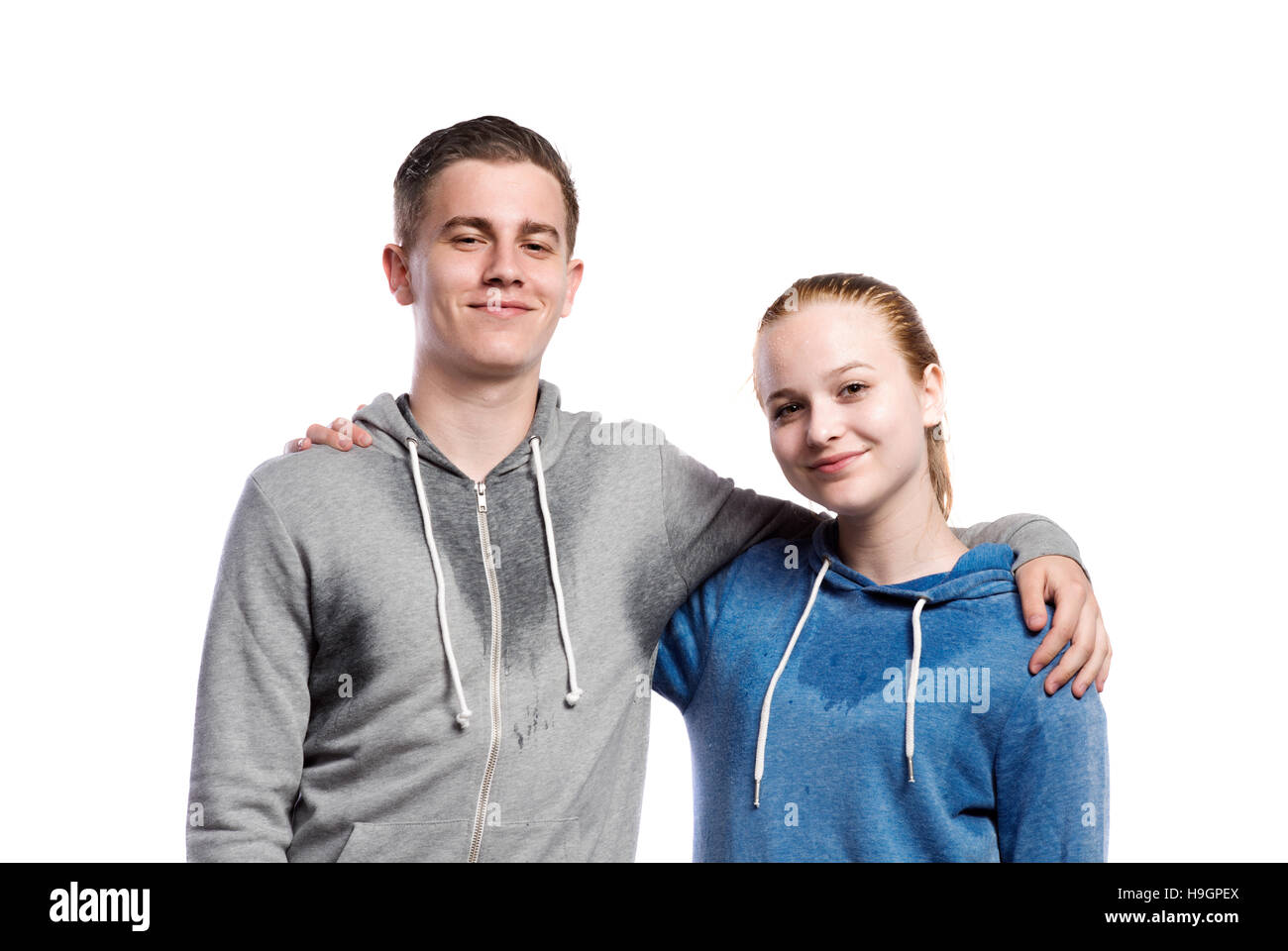 Teenage boy and girl in sweatshirts. Studio shot, isolated. Stock Photo