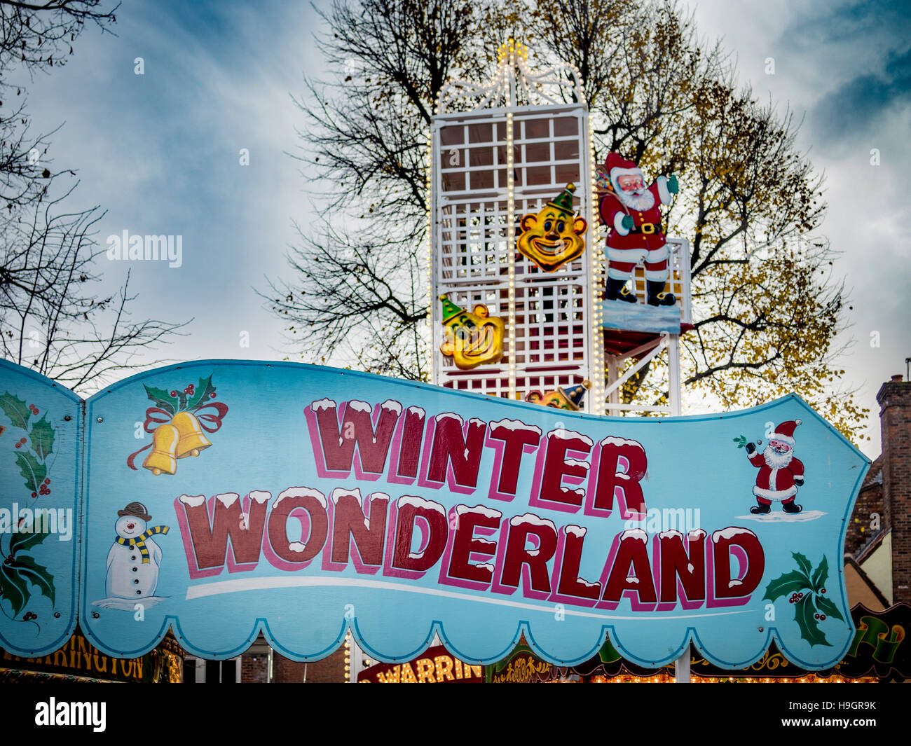 Winter Wonderland sign at fair with Helter Skelter in background Stock Photo