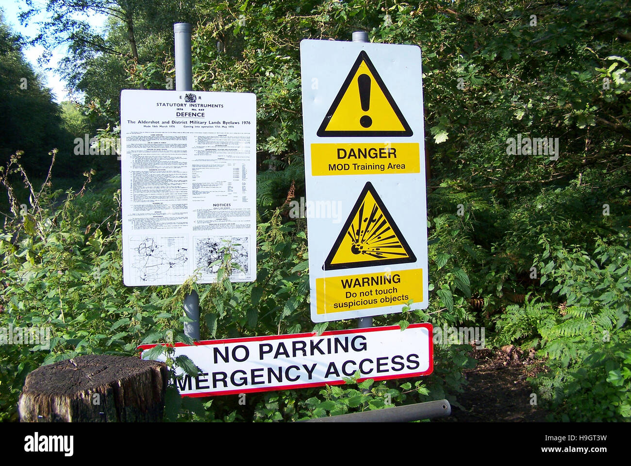 Danger warning signs at a Ministry of Defence training area, warning the public about unexploded bombs. Stock Photo