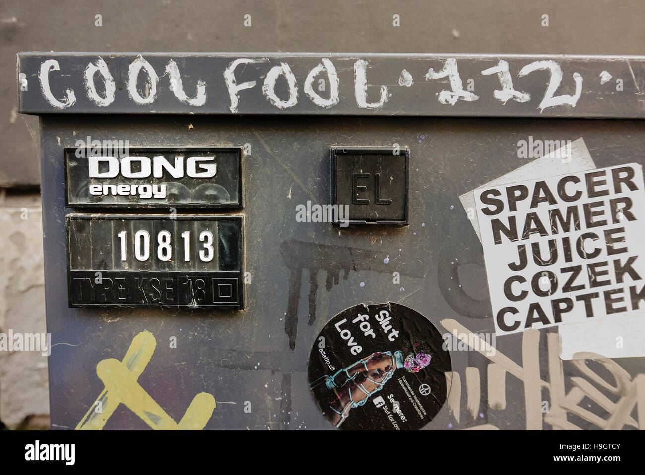 Electrical street cabinet with label 'Dong Energy', graffiti and stickers Stock Photo