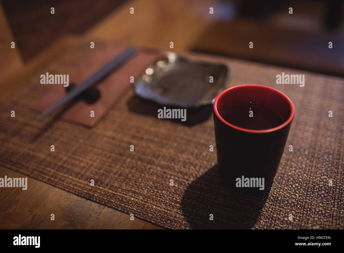 Cup of sake on dining table Stock Photo