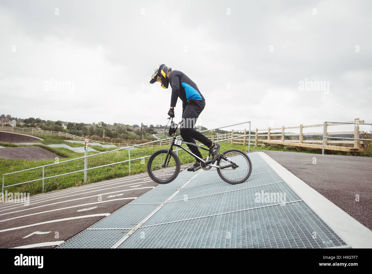 Cyclist preparing for BMX racing at starting ramp Stock Photo - Alamy
