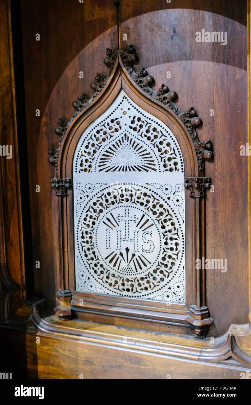 Metal screen at the confessional box in a Catholic church. Stock Photo