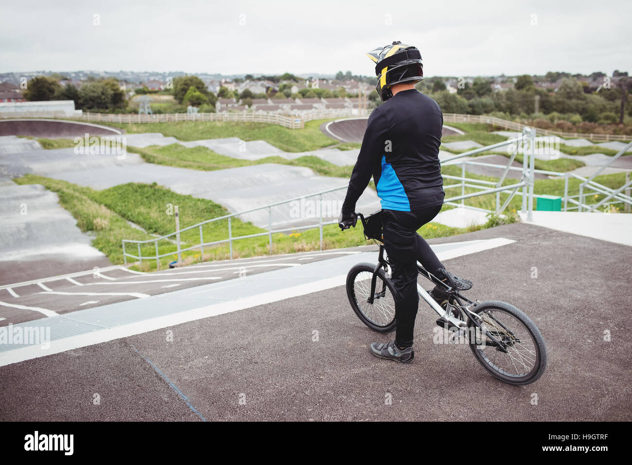 Cyclist standing with BMX bike at starting ramp Stock Photo - Alamy