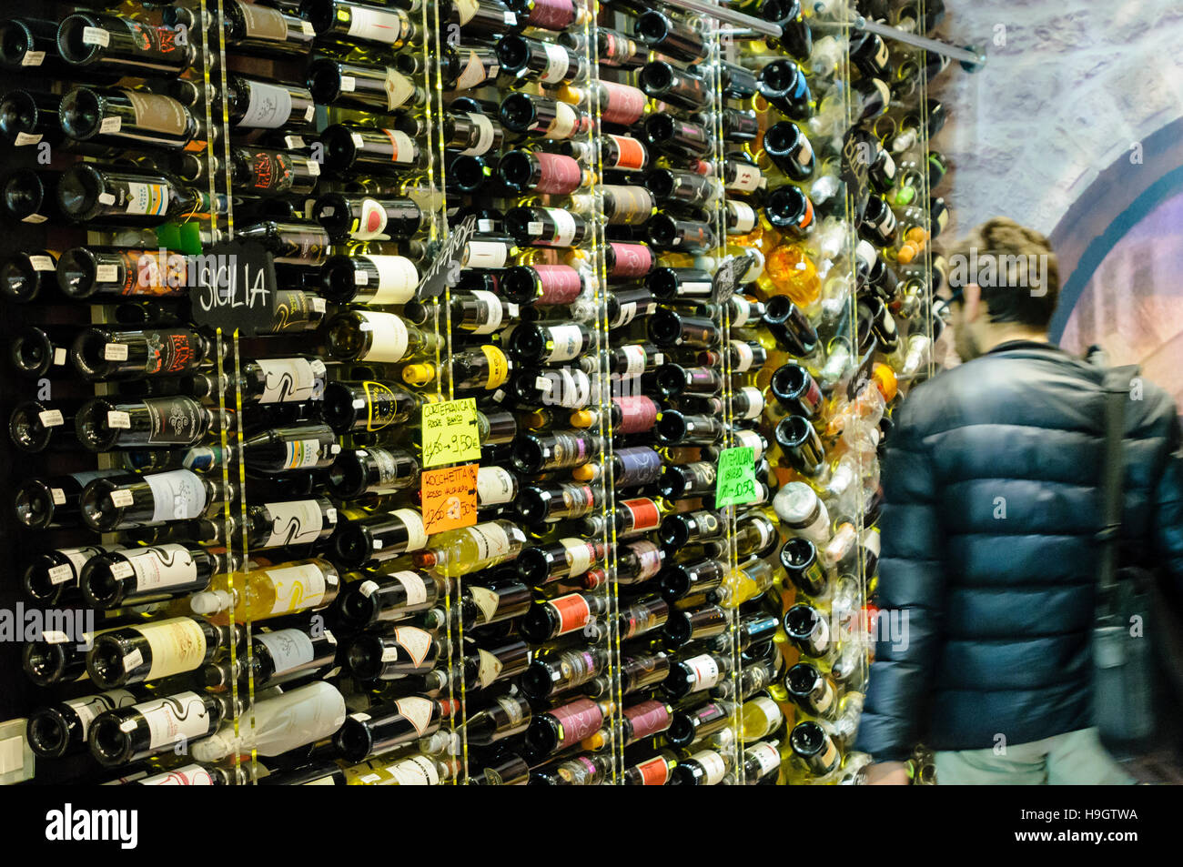 Customer examines wines for sale in an Italian Wine Cellar Stock Photo