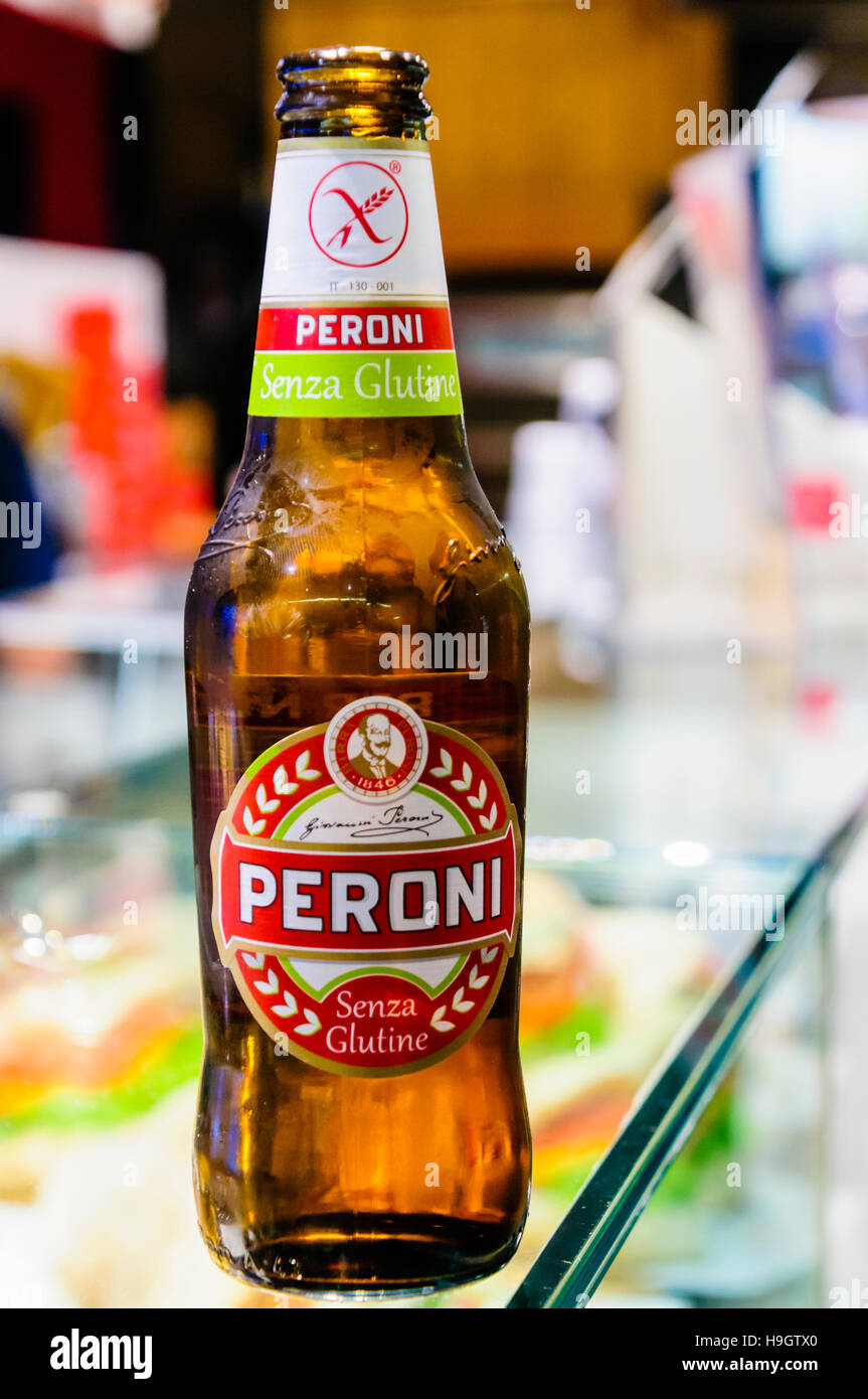 Bottle of Gluten Free Peroni lager on the glass counter of an Italian Bar. Stock Photo