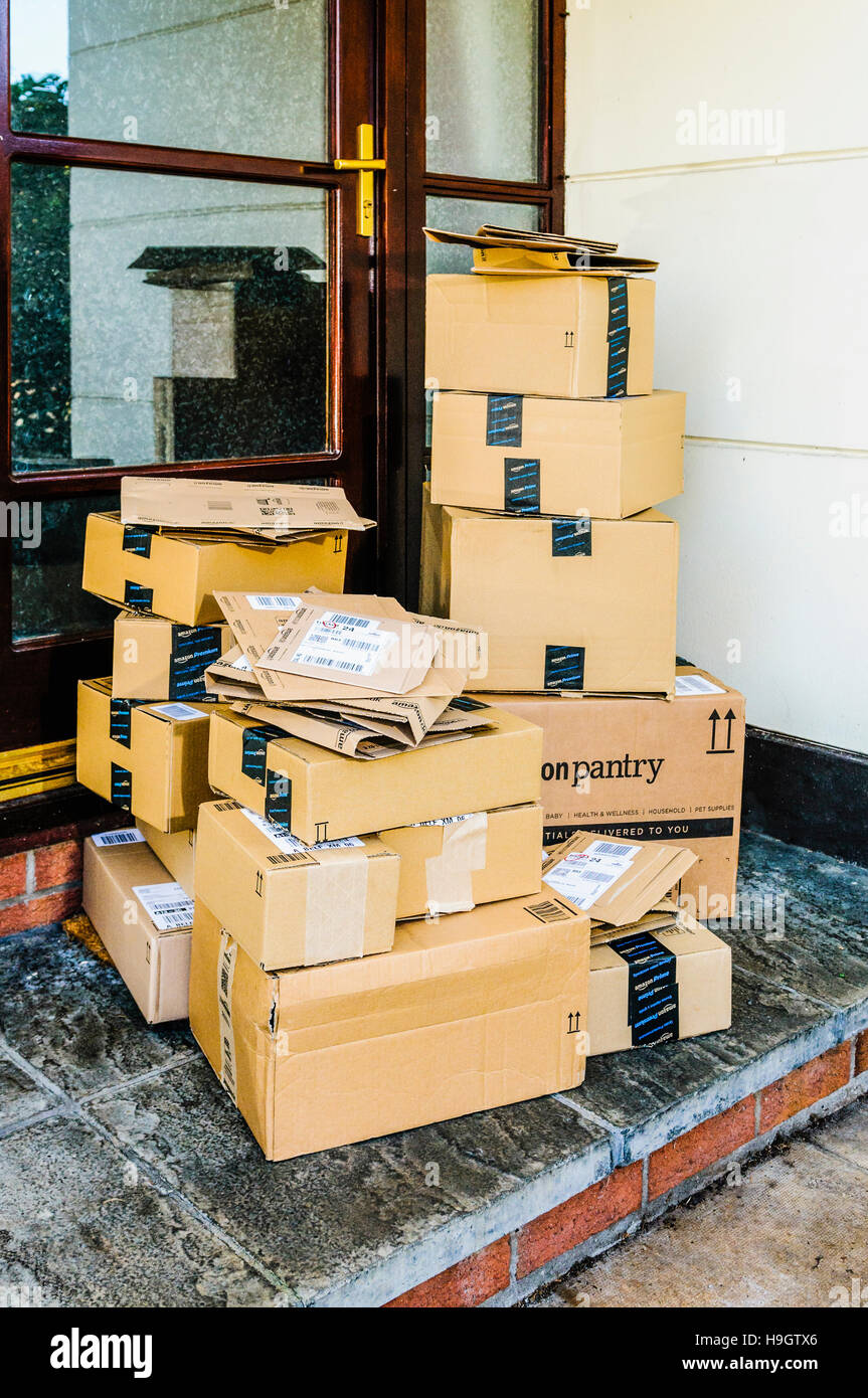 Amazon, Amazon Prime, and Amazon Pantry boxes on the front step of a house after being delivered. Stock Photo