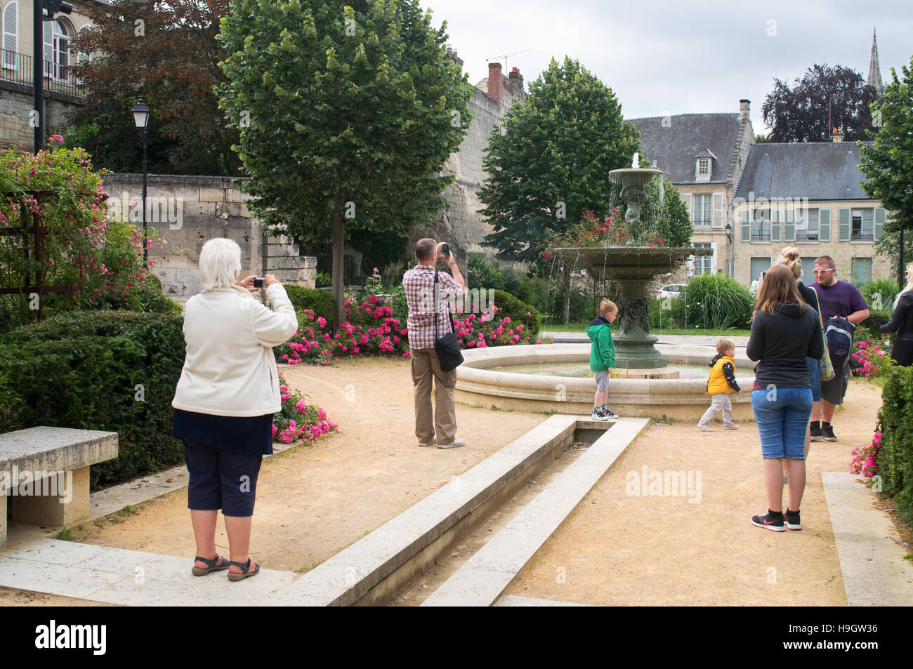 People photographing the fountain near the cathedral, Soissons, Aisne department,  Picardy,  France,  Europe Stock Photo