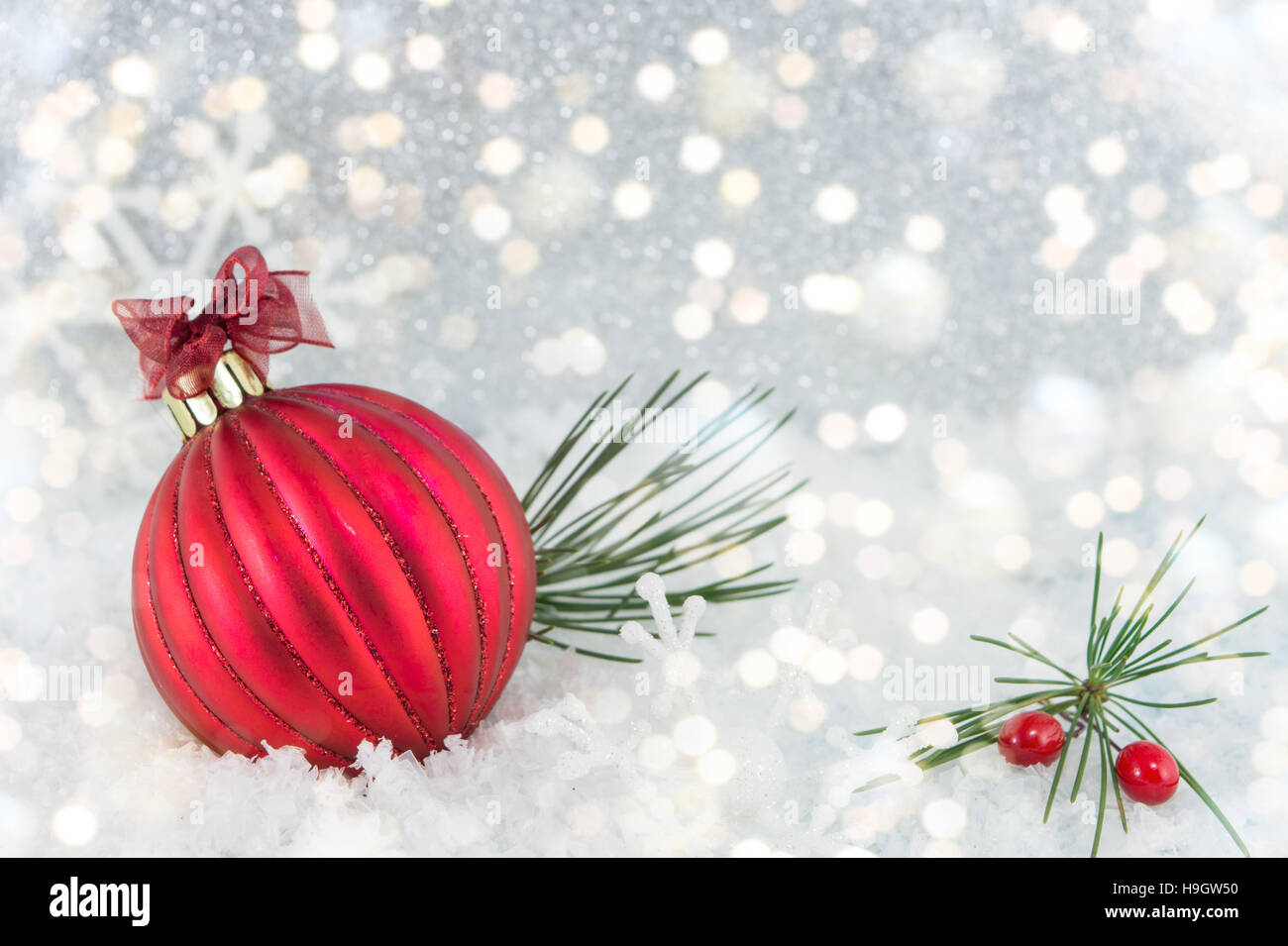 Red Christmas ball on shiny silver background Stock Photo