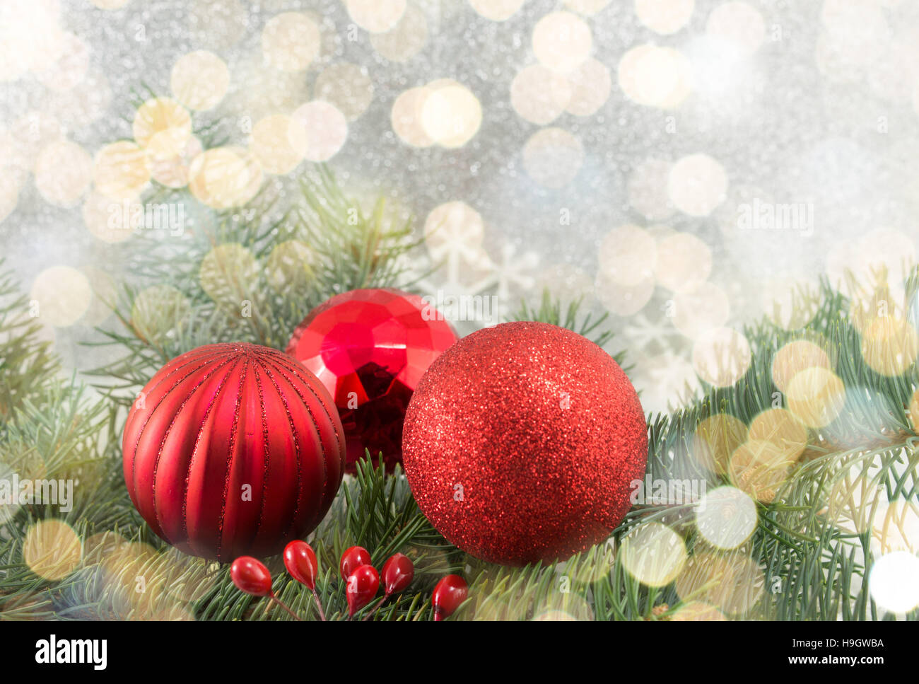 Red Christmas balls on shiny silver background Stock Photo - Alamy