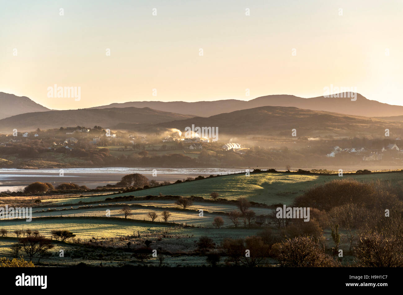 Ardara, County Donegal, Ireland weather. 23rd November 2016.Smoke from turf (peat) fires is illuminated by the rising sun on a cold, crisp morning over the village on Ireland's 'Wild Atlantic Way'. Credit:  Richard Wayman/Alamy Live News Stock Photo