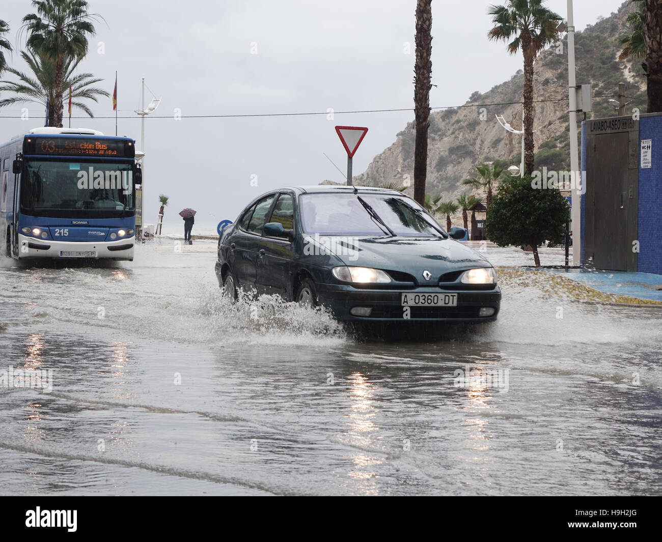 Vehicles drive through flooded streets in La Cala, Benidorm, Alicante province, Spain after a storm and flash flooding on the streets. Stock Photo