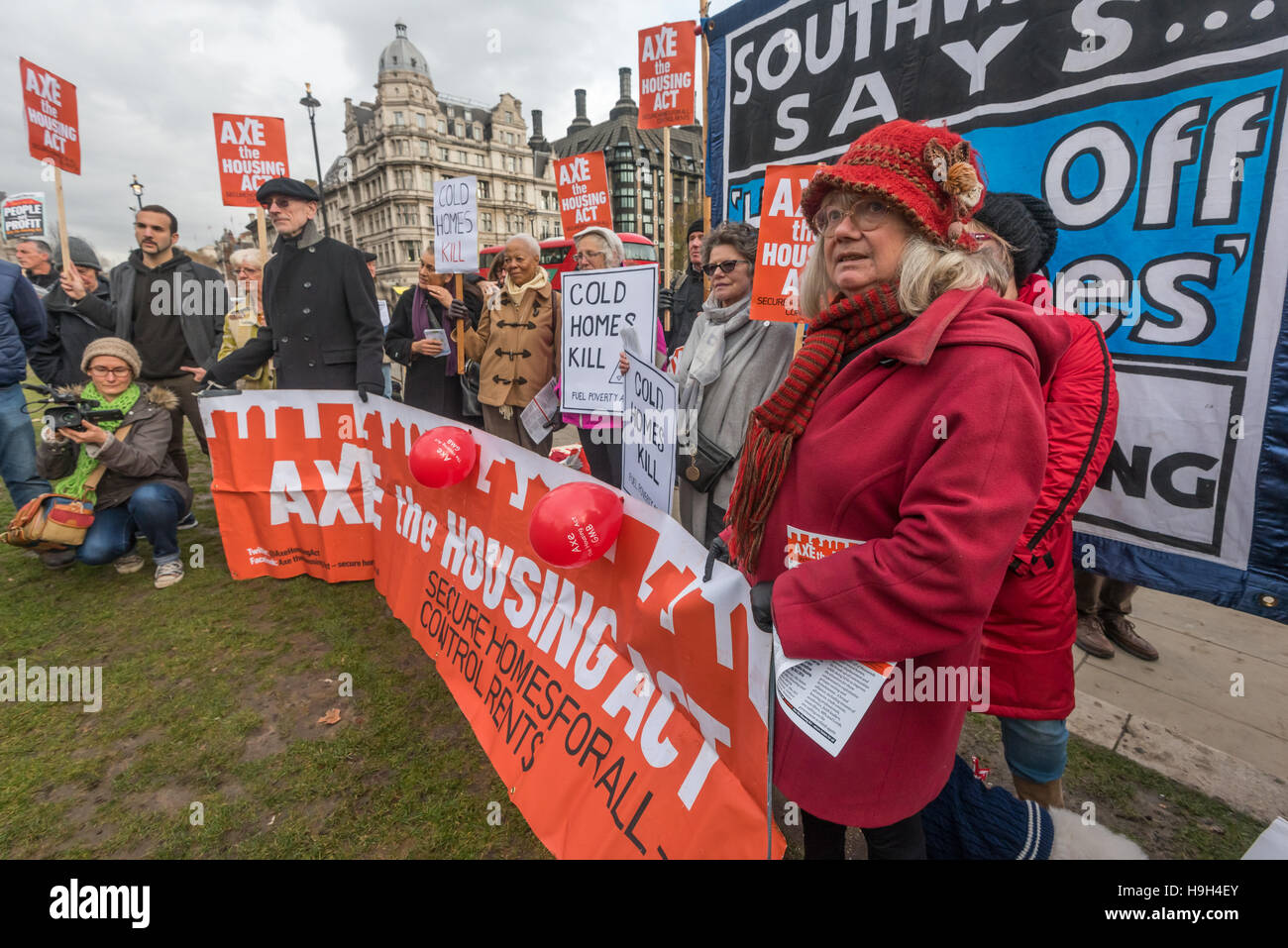London, UK. Housing campaigners from Axe the Housing Act at a rally opposite parliament as the