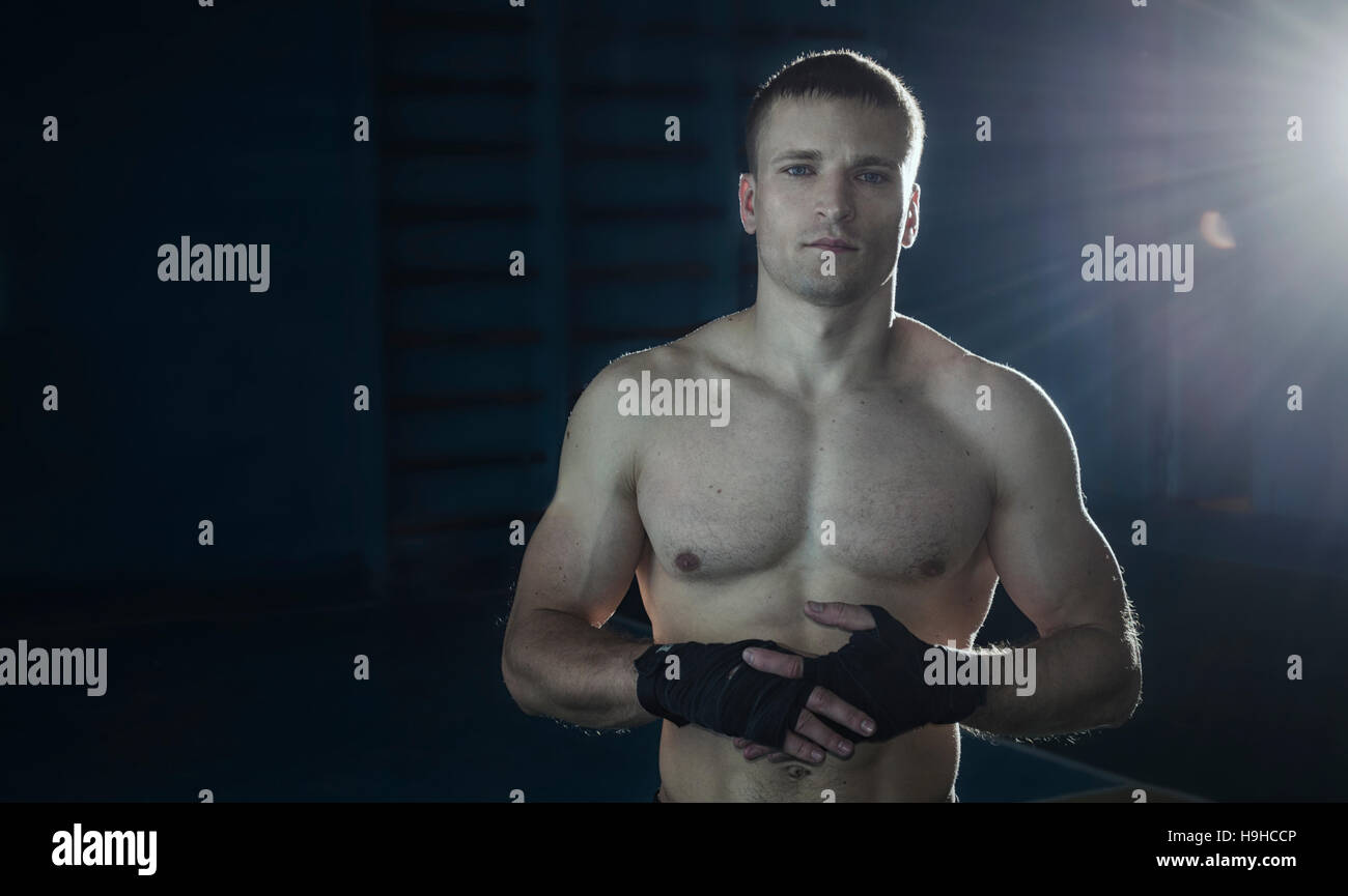 Young athletic man with boxing bandages on his hands Stock Photo