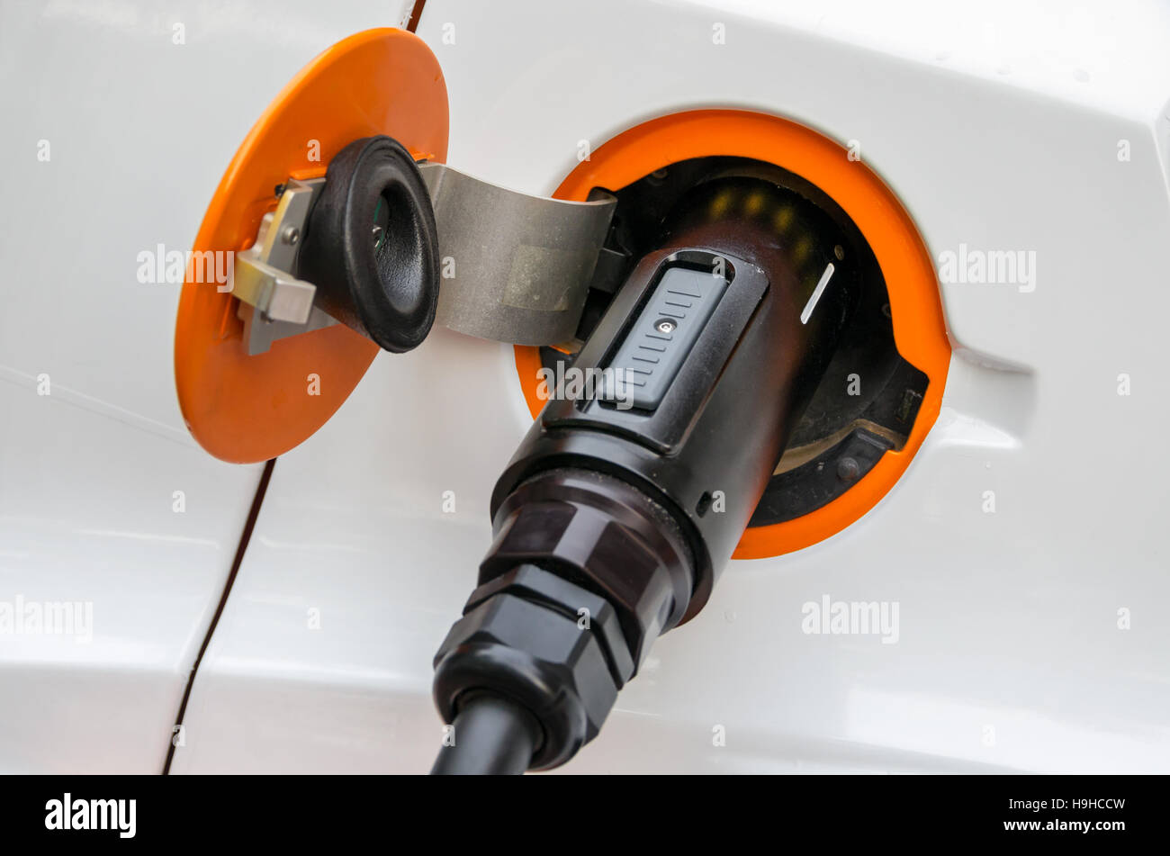 Charging cable with a plug in socket of a electric car Stock Photo Alamy