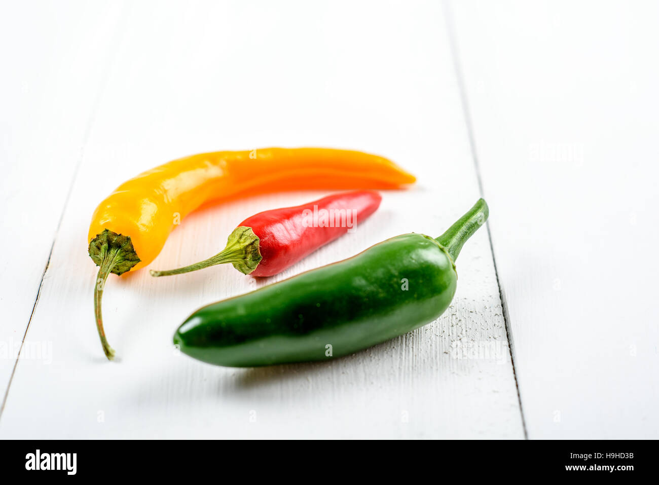 Yellow, Red And Green Chili Pepper On White Stock Photo