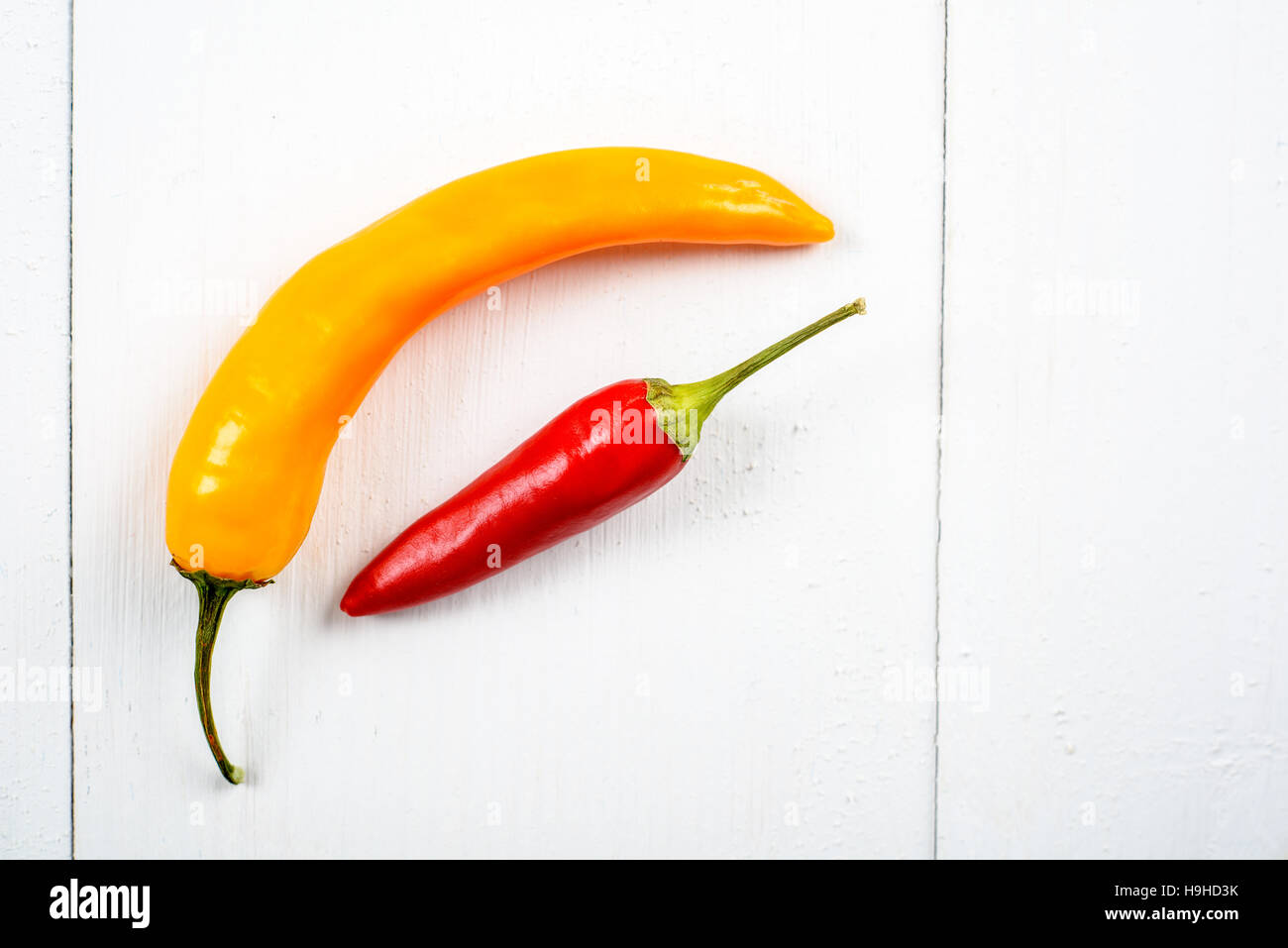 Red And Yellow Chili Pepper On White Stock Photo - Alamy